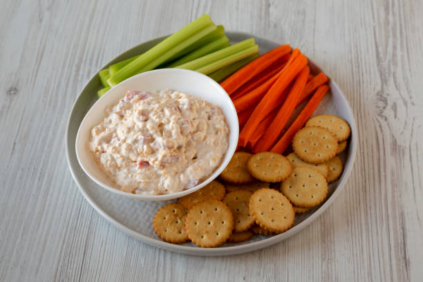istock Homemade Pimento Cheese Dip with carrots, celery and crackers, low angle view. Close-up. 1195770256