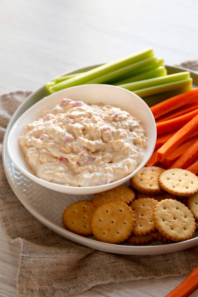 istock Homemade Pimento Cheese Dip with carrots, celery and crackers, side view. Close-up. 1195770306