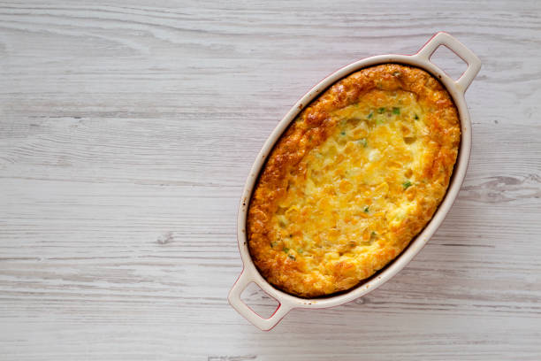 istock Homemade Cheddar Corn Pudding Casserole on a white wooden background, overhead view. Flat lay, top view, from above. Copy space. 1195770876