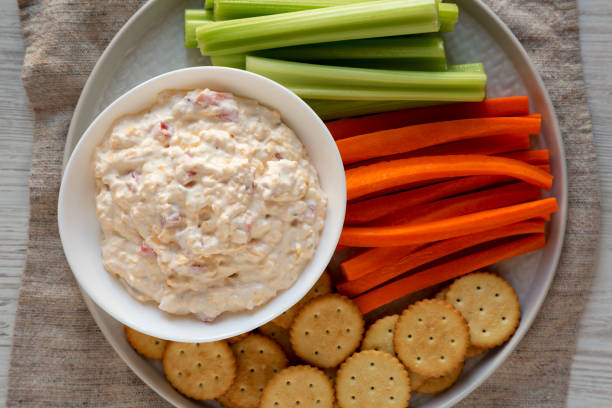 istock Homemade Pimento Cheese Dip with carrots, celery and crackers, top view. Flat lay, overhead, from above. Close-up. 1195771104