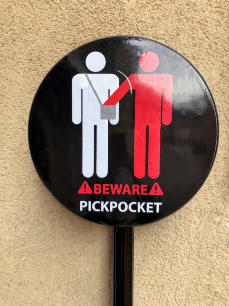 istock beware of pickpocket sign on wall 1195772774