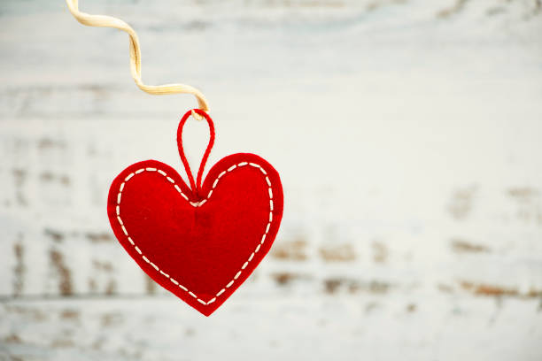istock Valentine's day greeting card. Red heart on a wooden white blue background. Creative card before Valentine's Day. 1195774821