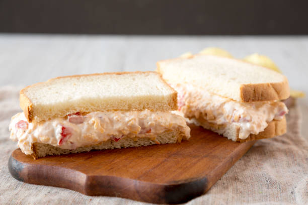 istock Delicious Homemade Pimento Cheese Sandwich with chips on a rustic wooden board, side view. Closeup. 1195777944