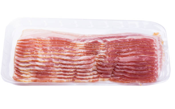 istock Vacuum packed bacon rashers isolated on white background. 1195785361