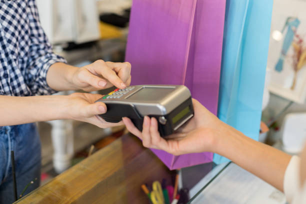 istock Female customer paying for clothes 1195786162