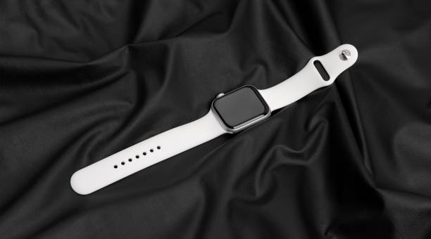 Apple Watch Series 5 Silver Aluminum Case with Sport Band White color. Rostov-on-Don, Russia - December 2019. Apple Watch Series 5 Silver Aluminum Case with Sport Band White color. New smart watches from APPLE on a black surface made of leather. bangle photos stock pictures, royalty-free photos & images