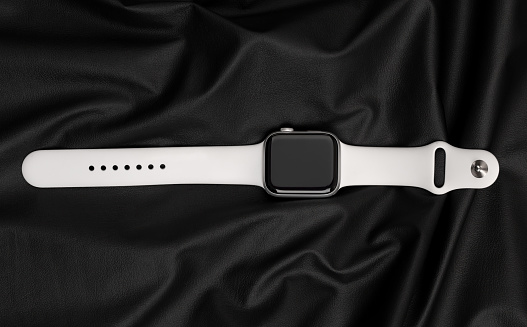 Rostov-on-Don, Russia - December 2019. Apple Watch Series 5 Silver Aluminum Case with Sport Band White color. New smart watches from APPLE on a black surface made of leather.