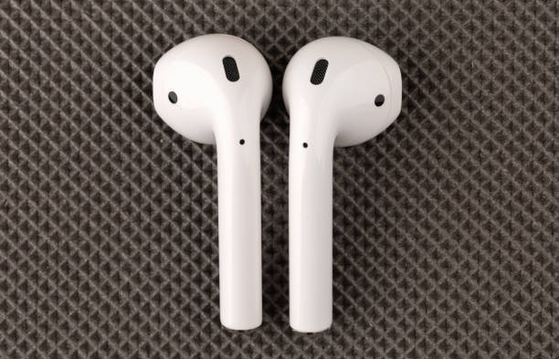 apple airpods sobre una superficie gris. - editorial use audio fotografías e imágenes de stock