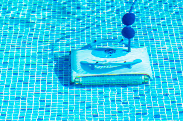 istock Cleaning the pool bottom with an underwater vacuum cleaner 1195790082