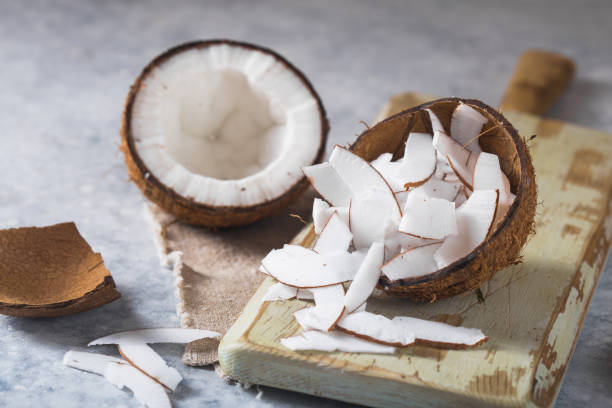 istock Cracked fresh coconut  and slice nut on concrete background, space for text Food ingredients, healthy lifestyle, paradise concept 1195791252