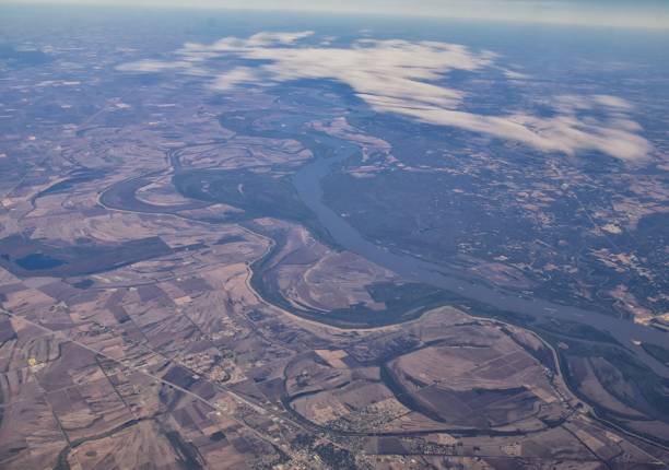 Mississippi River aerial landscape views from airplane over the border of Arkansas and Mississippi. Winding river and Rural town and cities, United States of America. USA. Mississippi River aerial landscape views from airplane over the border of Arkansas and Mississippi. Winding river and Rural town and cities, United States of America. USA. mississippi delta stock pictures, royalty-free photos & images