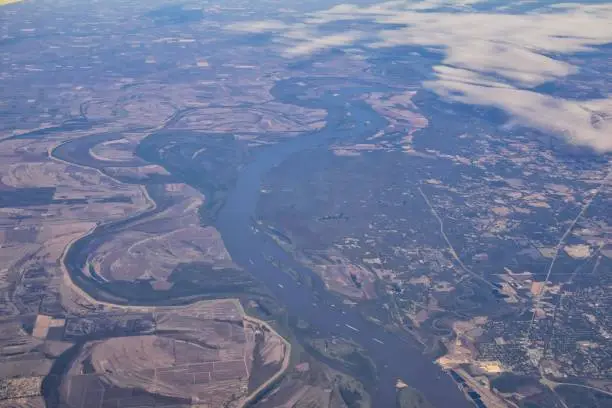 Mississippi River aerial landscape views from airplane over the border of Arkansas and Mississippi. Winding river and Rural town and cities, United States of America. USA.