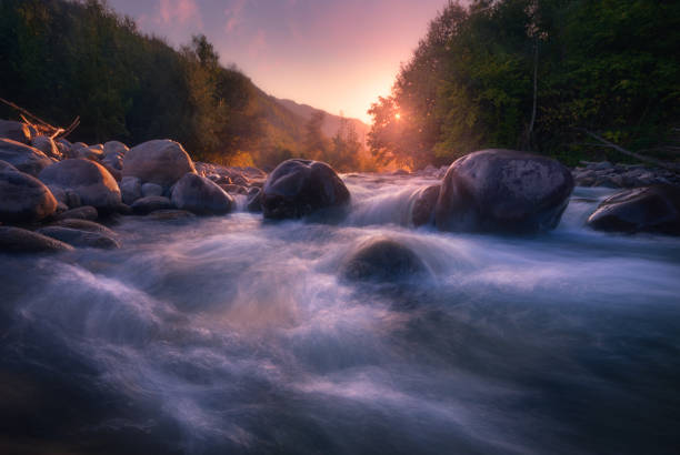istock Beautiful sunny summer landscape. Fast flowing mountain river 1195803895