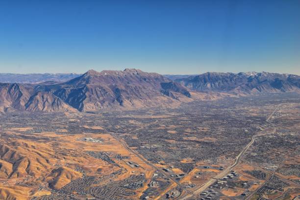 istock Wasatch Front Rocky Mountain Range Aerial view from airplane in fall including urban cities and the Great Salt Lake around Salt Lake City, Utah, United States of America. USA. 1195806304