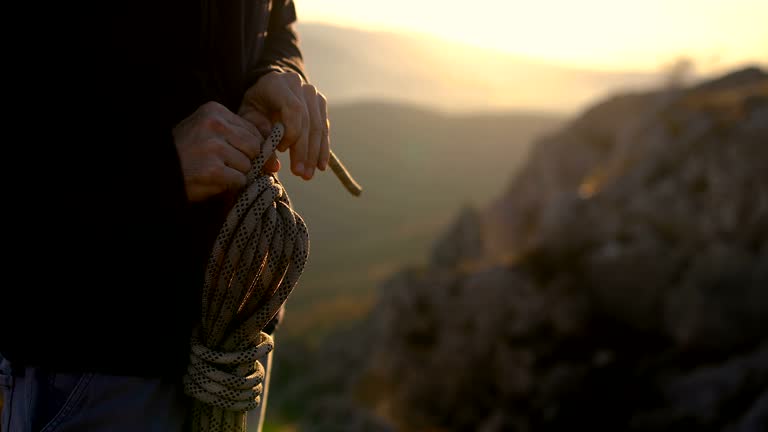 The climber coil a rope to put it in the backpack when it is not needed