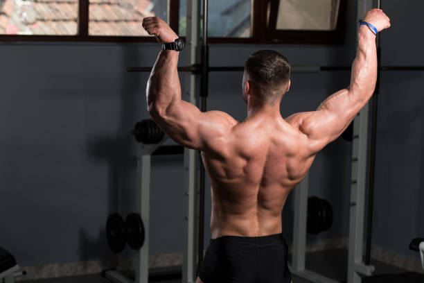 istock Serious Bodybuilder Standing In The Gym 1195808244