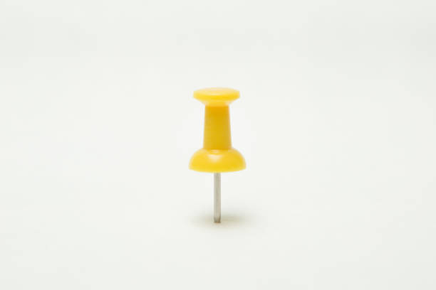istock Close up of Yellow pin on white background 1195814899