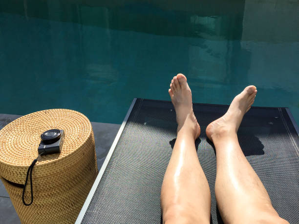 istock Sunbathing by swimming pool 1195818198