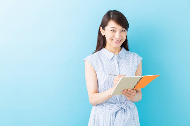istock asian women is taking notes 1195825953