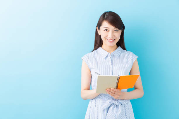 istock asian women is taking notes 1195826042