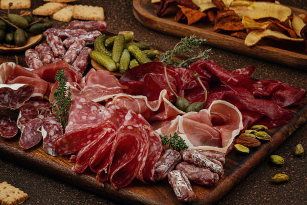 istock Appetizers table with differents antipasti, cheese, charcuterie, snacks and wine. Sausage, ham, tapas, olives, cheese and crackers for buffet party. 1195830297
