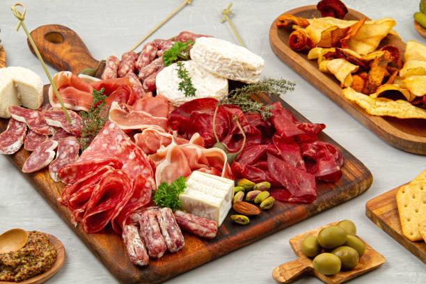 istock Appetizers table with differents antipasti, charcuterie, snacks and wine. Sausage, ham, tapas, olives, cheese and crackers for buffet party 1195830332