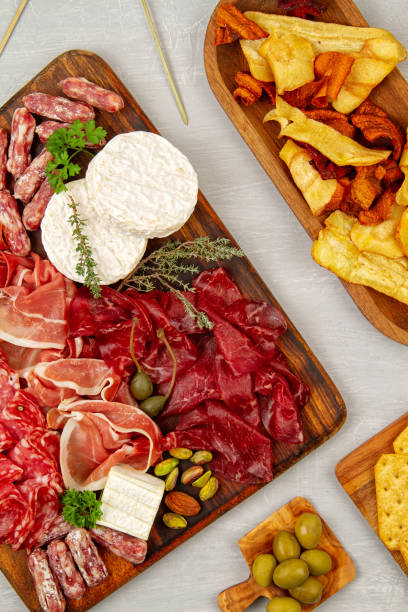 istock Appetizers table with differents antipasti, charcuterie, snacks and wine. Sausage, ham, tapas, olives, cheese and crackers for buffet party 1195830333