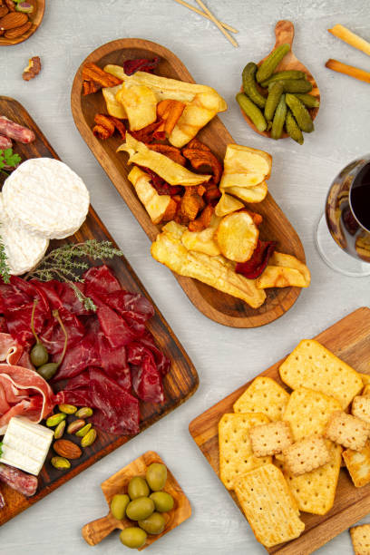 istock Appetizers table with differents antipasti, charcuterie, snacks and wine. Sausage, ham, tapas, olives, cheese and crackers for buffet party 1195830335
