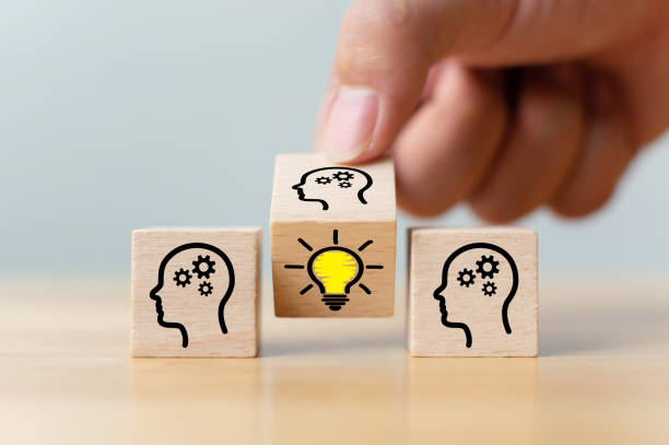 istock Concept creative idea and innovation. Hand flip over wooden cube block with head human symbol and light bulb icon 1195830456