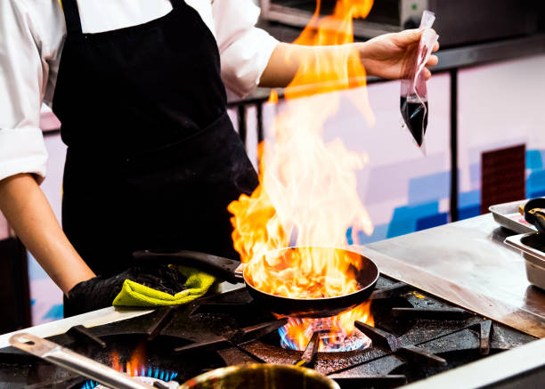 istock Chef cooking, Chef preparing food in the kitchen, Chef decorating dish, closeup 1195831262