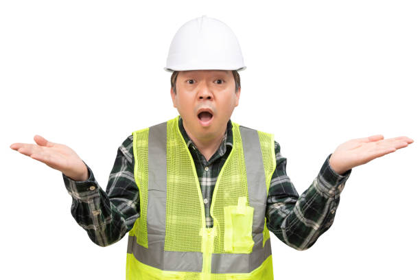 istock A middle-aged Asian man worker who raises both hands and expresses surprise. 1195836081