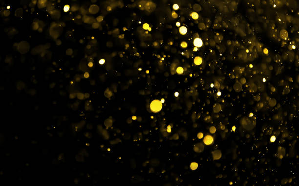 istock Gold color bokeh light on black background 1195842171
