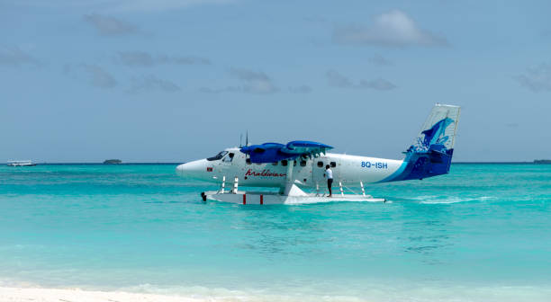 A seaplane floating in the blue water of Maldives stock photo