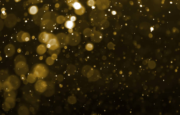 istock Gold color bokeh light on black background 1195842226