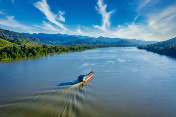 Photo of Laotian ship cruising along the Mekong River in Laos Aerial Drone View