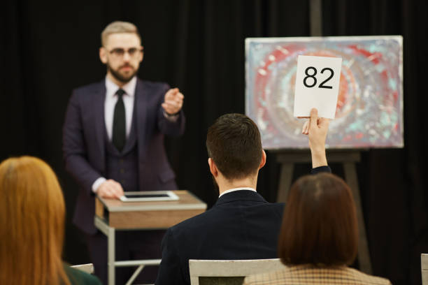 istock Man selling the painting at auction 1195845048