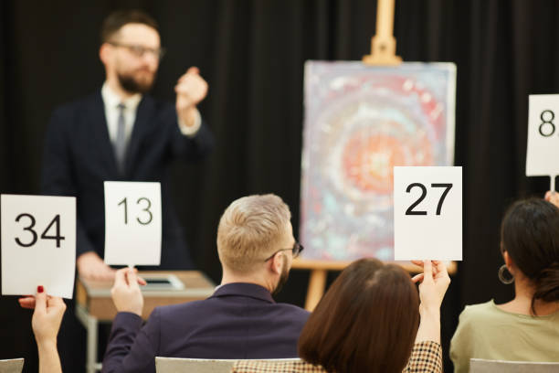 istock Business people at auction 1195845466