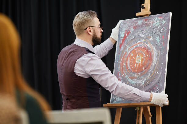 istock Artist with his painting 1195845544