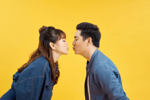 Profile side photo of charming spouses send air kiss isolated over vivid color background Profile side photo of charming spouses send air kiss isolated over vivid color background puckering stock pictures, royalty-free photos & images