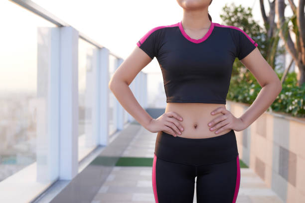 istock Close up of fit woman's torso with her hands on hips. 1195849470