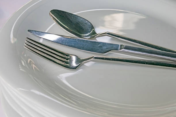 istock spoon, knive, fork on plates in restaurant 1195849474
