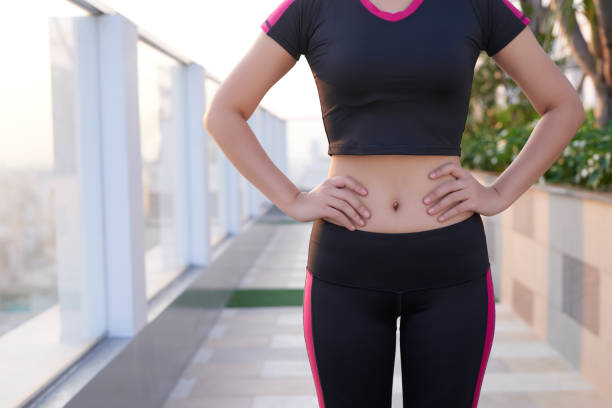 istock Close up of fit woman's torso with her hands on hips. 1195849788