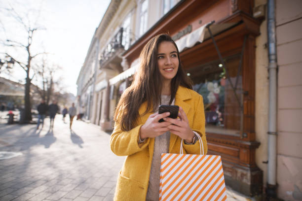 istock Portrait of a beautiful woman using a mobile 1195851175