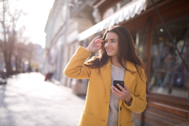 istock Portrait of a beautiful woman using a mobile 1195851178