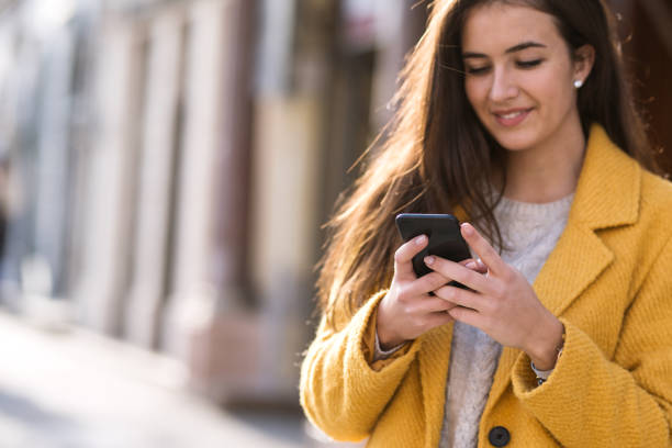 istock Portrait of a beautiful woman using a mobile 1195851179