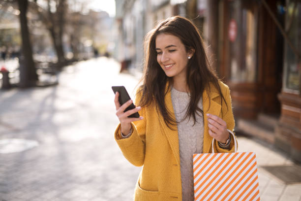 istock Portrait of a beautiful woman using a mobile 1195851180