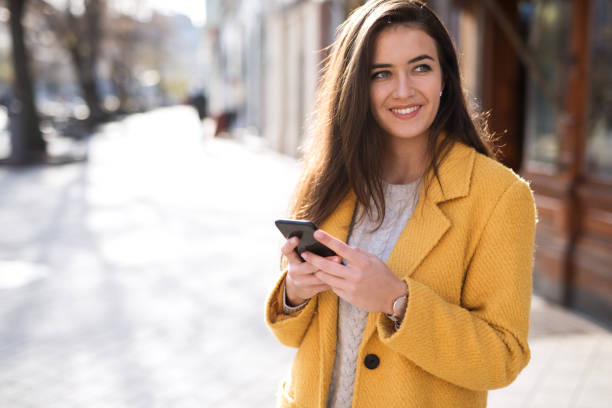 istock Portrait of a beautiful woman using a mobile 1195851186