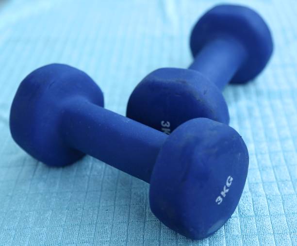 istock Two blue dumbbells on the towel side view 1195855091