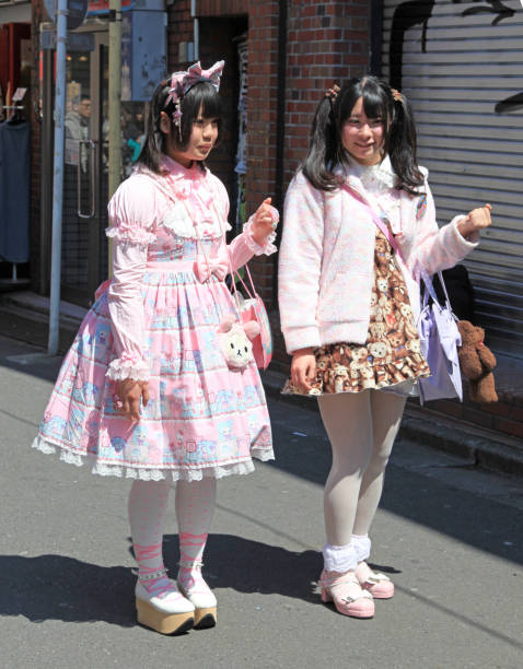 Cosplay young women in pink Taken on 8th April 2012 in Harajuku, Tokyo, Japan. Two dressed up young women in Harajuku wearing pink Lolita style outfits with accessories and make up. asian women in stockings stock pictures, royalty-free photos & images