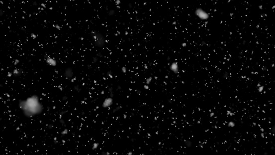 Falling slow snow isolated on black background in 4K to be used for composing, motion graphics, Large and small snow snowflakes, Isolated falling snow,
